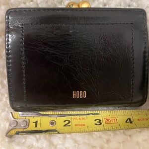 HOBO Violet Kisslock card case
NWT 
Black exterior
Brown interior
SKU #VI-32480
